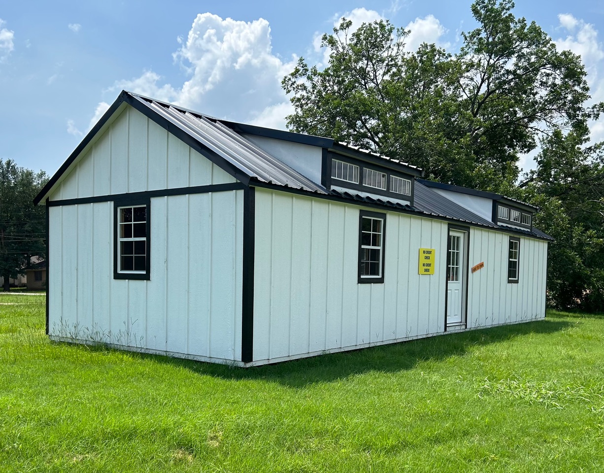A NorthStar portable cabin building on a grassy lot